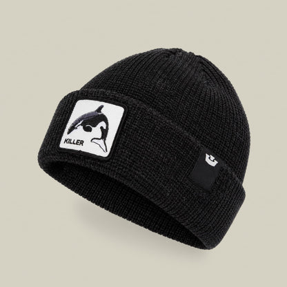 The Killer Whale Beanie by Goorin Bros is a black ribbed knit beanie with a white patch featuring a killer whale illustration and the word "KILLER" displayed on the front against a neutral background.