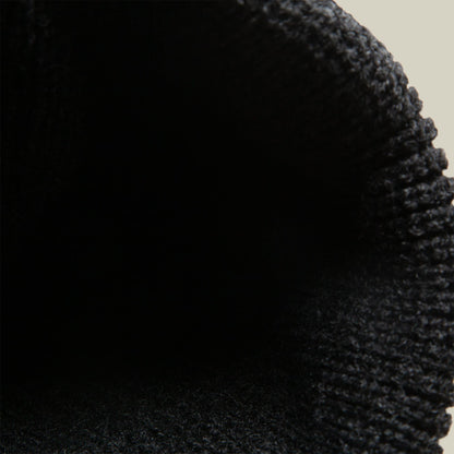 The Boss Beanie by Goorin Bros is a charcoal black knit beanie shown in close-up detail, showcasing its textured wool knit construction and ribbed cuff design against a neutral background.