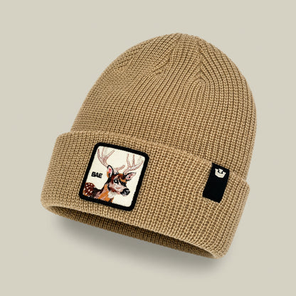 The Bae Beanie by Goorin Bros. is an everyday knit acrylic beanie featuring a patch with a deer head and the word “BAE” on the front, along with a small black rectangular label on the cuff.