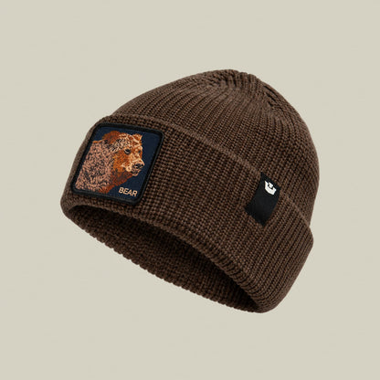 The Bear Beanie by Goorin Bros is a brown ribbed knit beanie with an embroidered bear patch on the front, displayed on a neutral background.