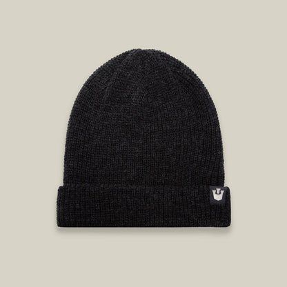 The Goorin Bros. Air to Fakie beanie in black features a folded brim, lightweight poly knit for all-season wear, and a small white logo tag on the right side, shown against a plain beige background.