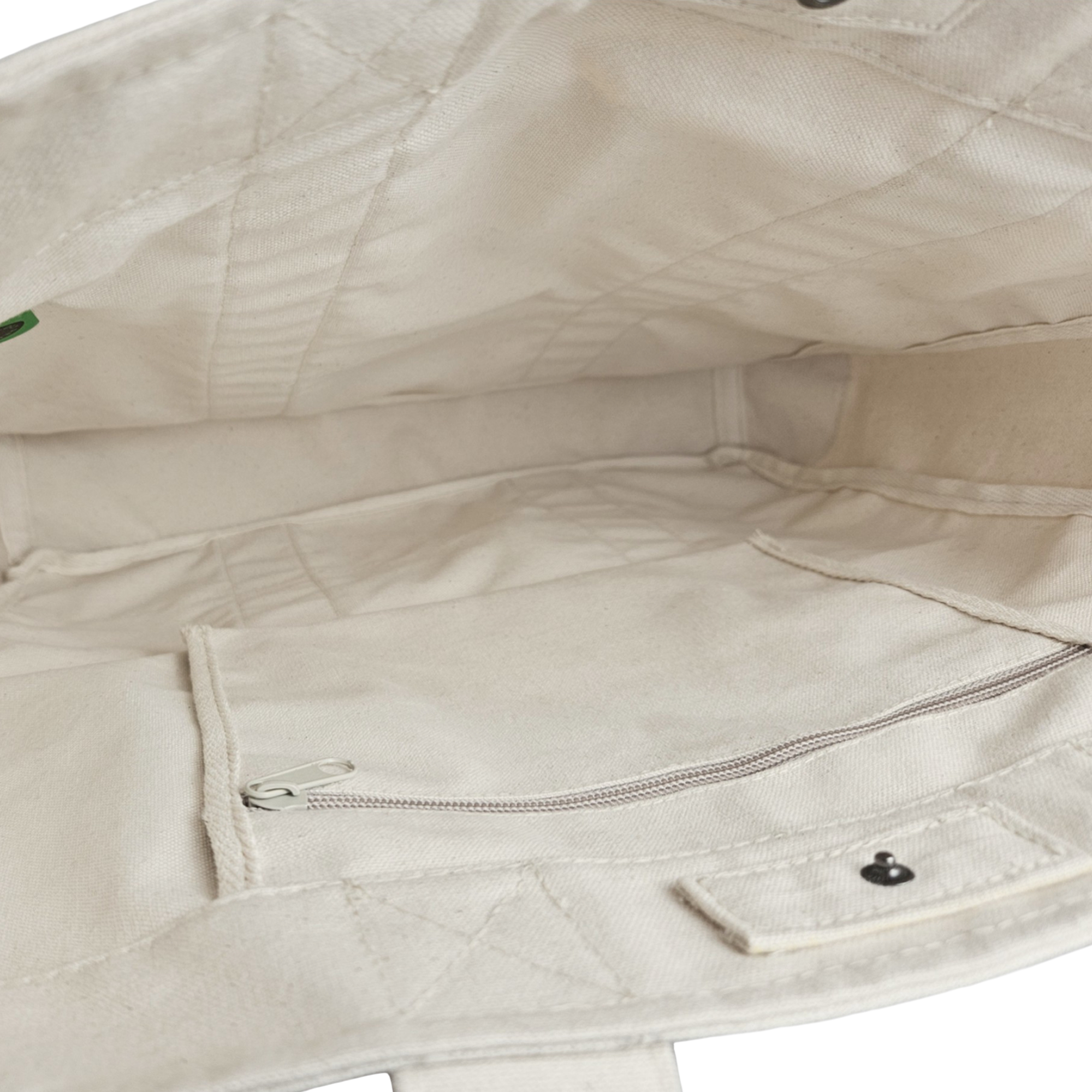 The Goorin Reworked Tote by Goorin Bros. is made in the USA and features a beige canvas lining, interior zippered pocket, and snap button pocket.