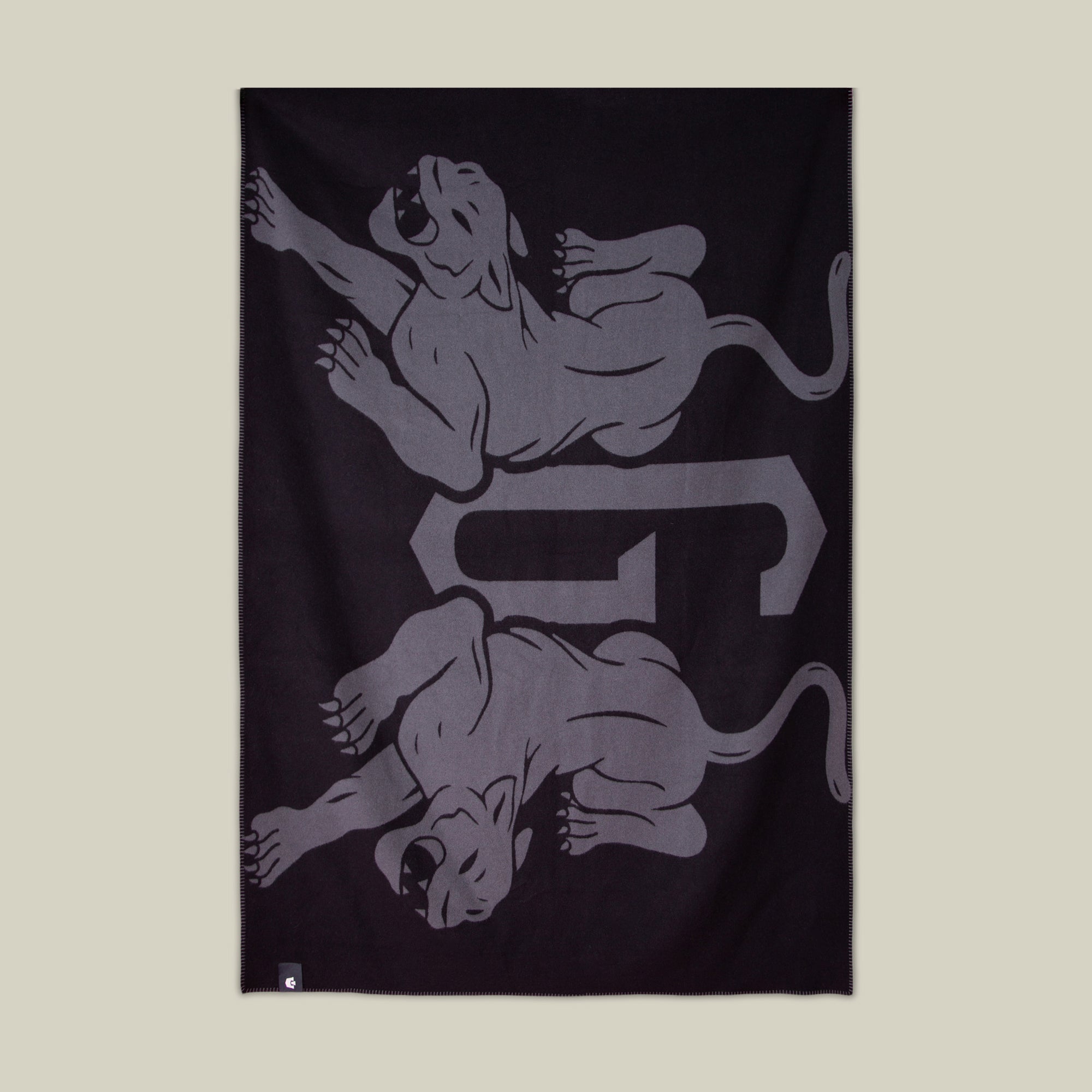 The Goorin Bros. Panther Crest Blanket in VOID features two mirrored stylized panthers and a bold central G—an ideal luxury throw for sophisticated living room decor.