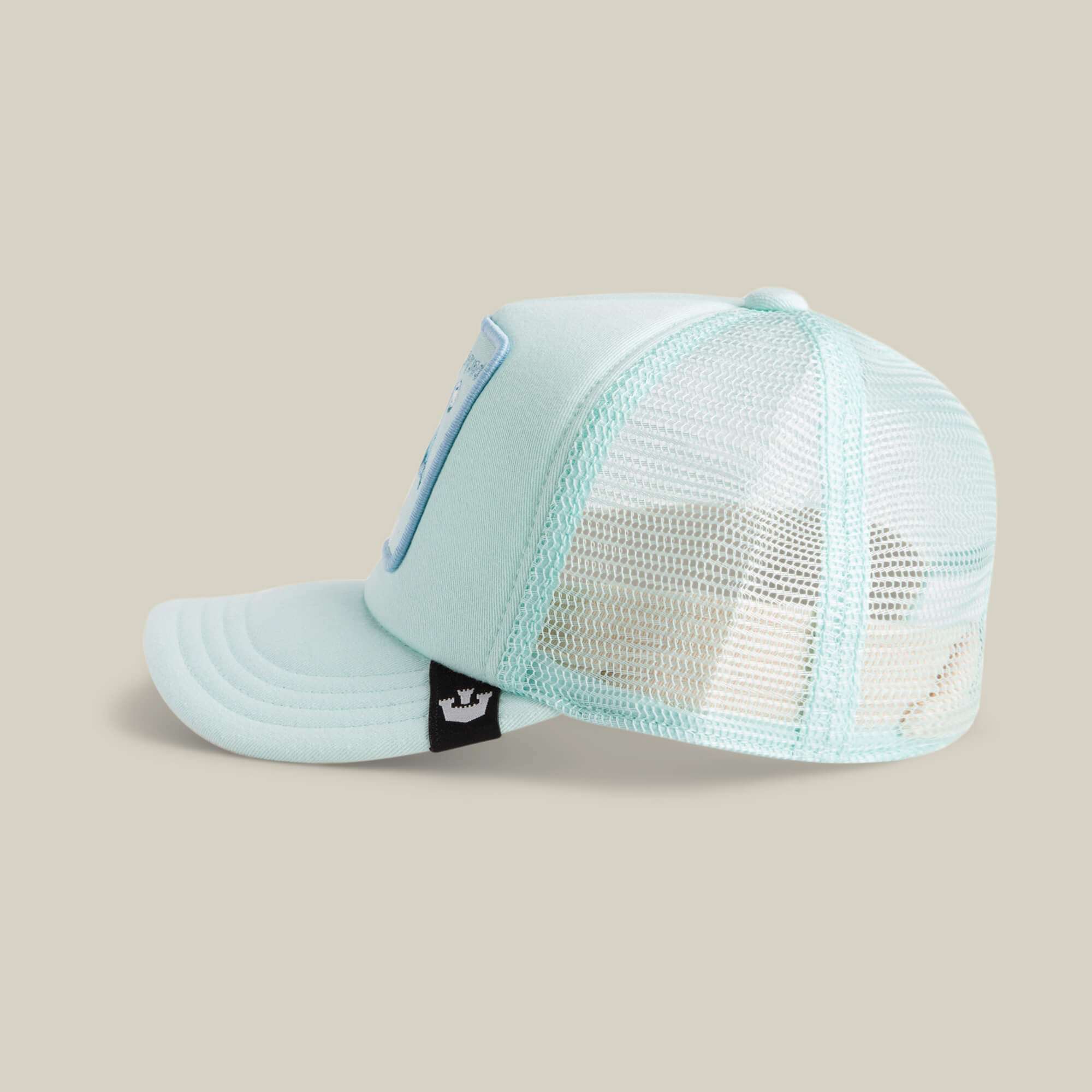 The Lil Squad kids cap by Goorin Bros. features light blue mesh panels, a curved brim, and a small black tag with a white crown logo—ideal for squad goals or rocking an embroidered flamingo look.