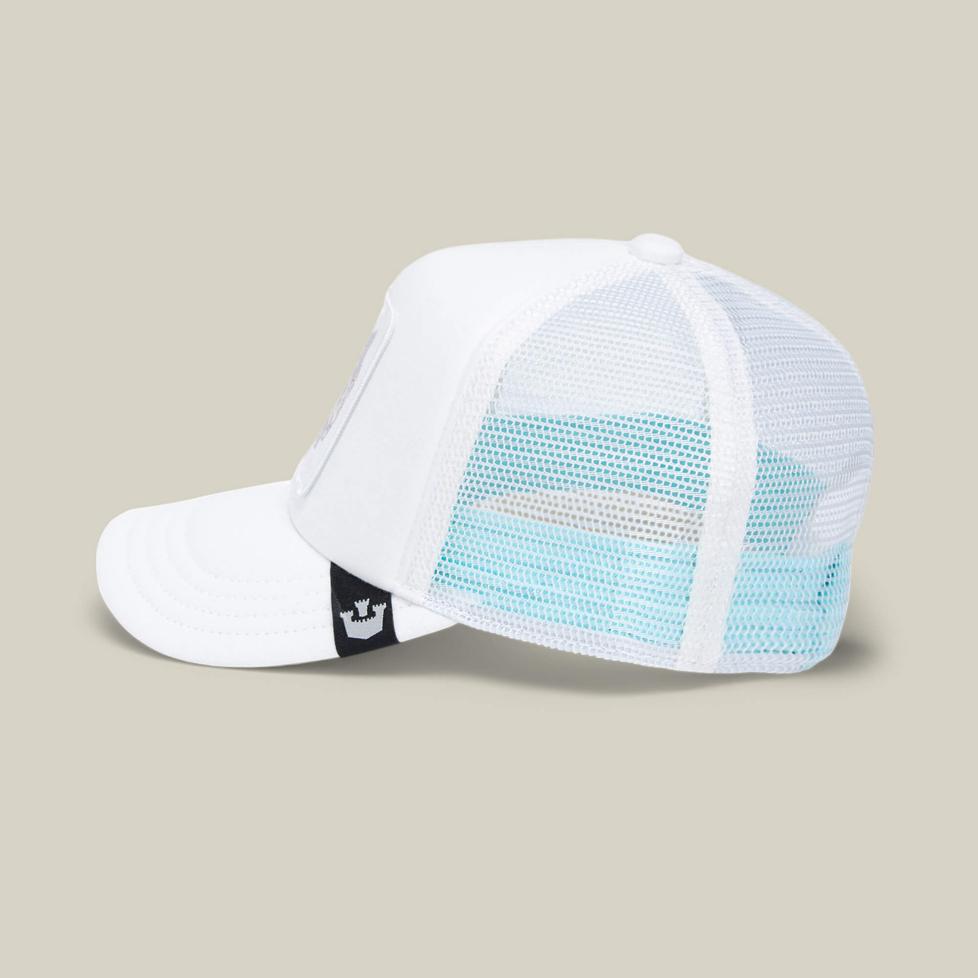 The Lil Pantherino by Goorin Bros. is a white mesh trucker hat for kids, featuring a black tag with a white crown logo. Shown from the side on a plain light background, it's perfect for everyday adventures.