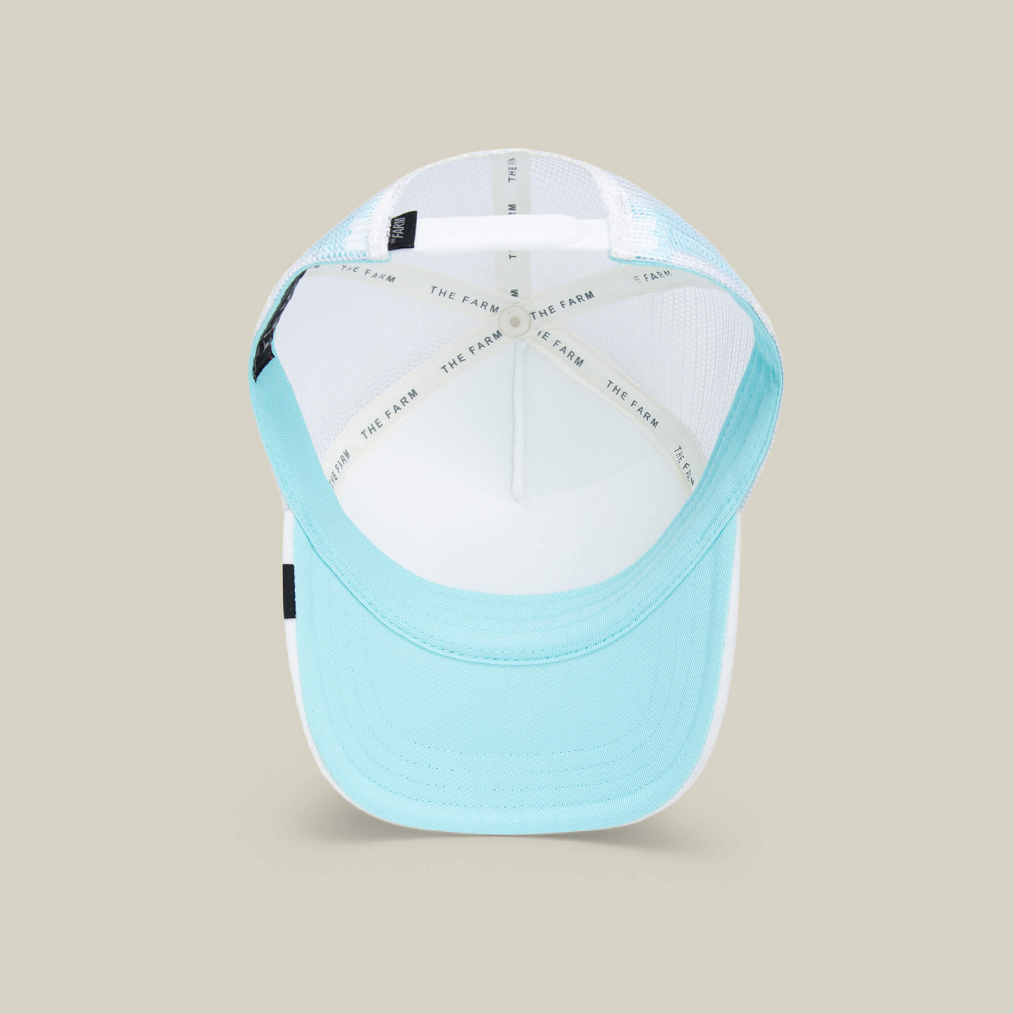A light blue and white mesh kids cap, Lil Pantherino by Goorin Bros., viewed from above reveals THE FARM printed on the inner seams. Its breathable design ensures all-day comfort.