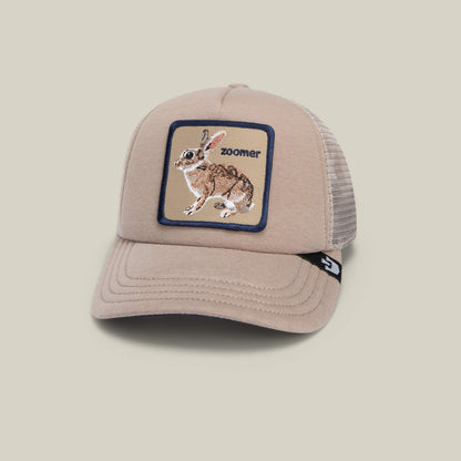 The OK Zoomer hat by Goorin Bros. is a beige mesh kids cap featuring a front embroidered rabbit patch and "zoomer" text—perfect for stylish adventures.