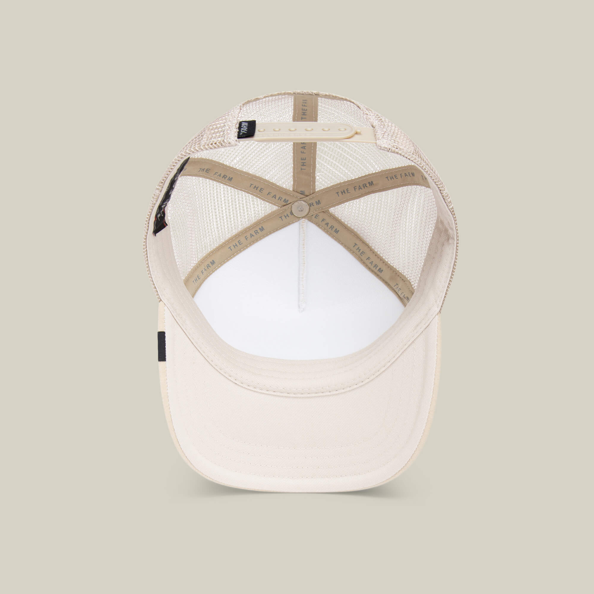 The Cuddle Time cap by Goorin Bros. is shown from above, featuring a mesh back, adjustable strap, and interior labels with THE FARM text.