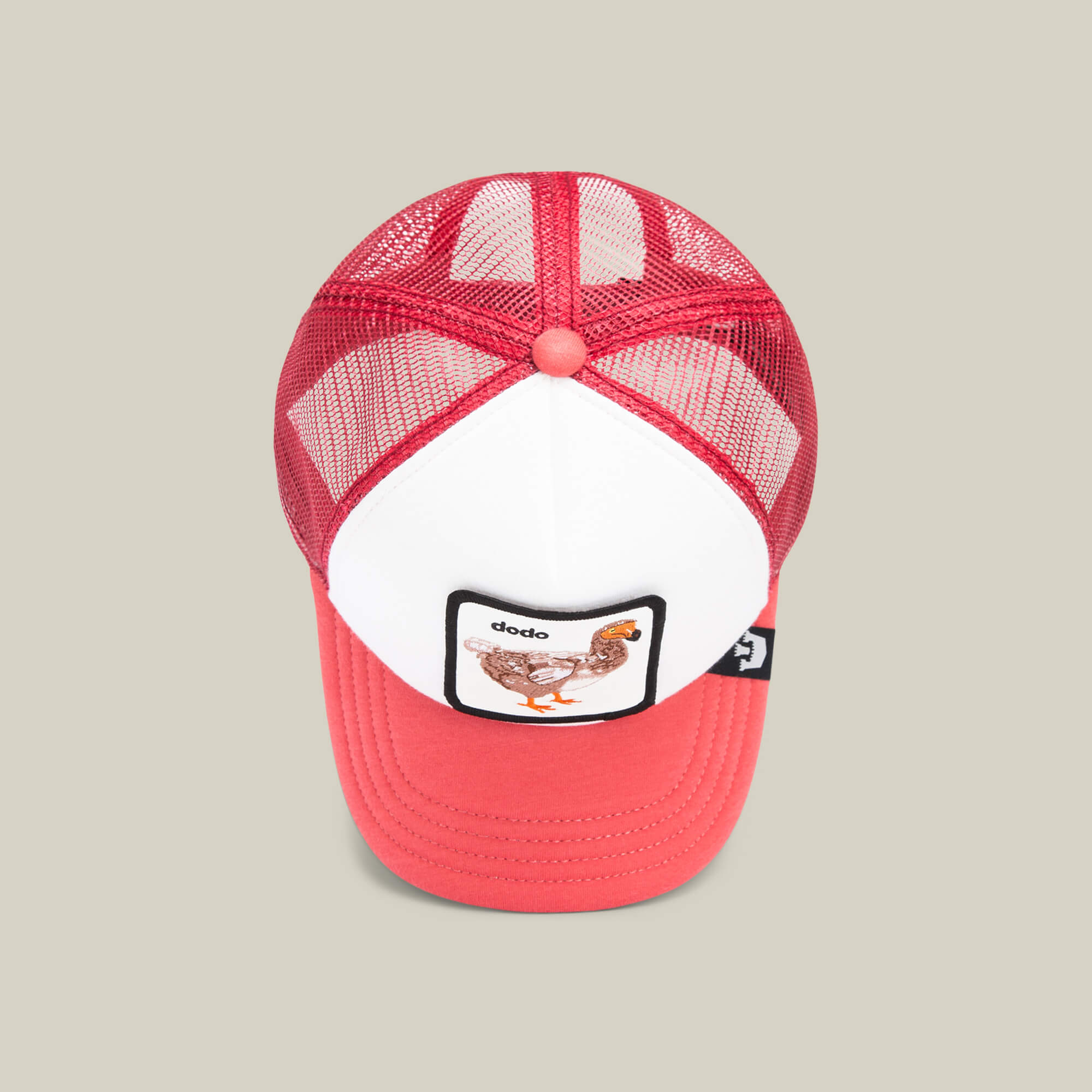 The Dodo Kiddo by Goorin Bros. is a red and white kids’ mesh cap with an embroidered dodo patch featuring a charming dodo illustration and the word "dodo" on the front.