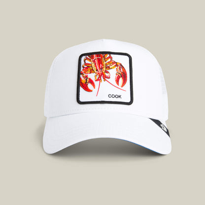 The Lemme Cook Mini by Goorin Bros. is a white kid-sized hat with a colorful lobster patch and "COOK" text, shown on a plain beige background under a soft mini spotlight.