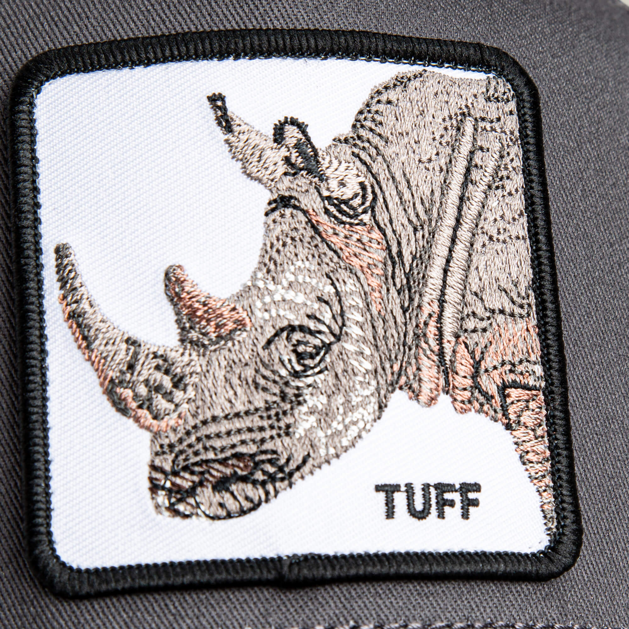 A close-up of The Tuff Rhino Mini patch by Goorin Bros., featuring an embroidered rhino and "TUFF" on dark fabric—ideal for adding bold style to any charcoal crown or mesh back cap.