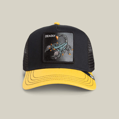 The Deadly Mini kids trucker hat by Goorin Bros. features a bold scorpion patch with DEADLY embroidered above it, and comes in black and yellow with a yellow brim.