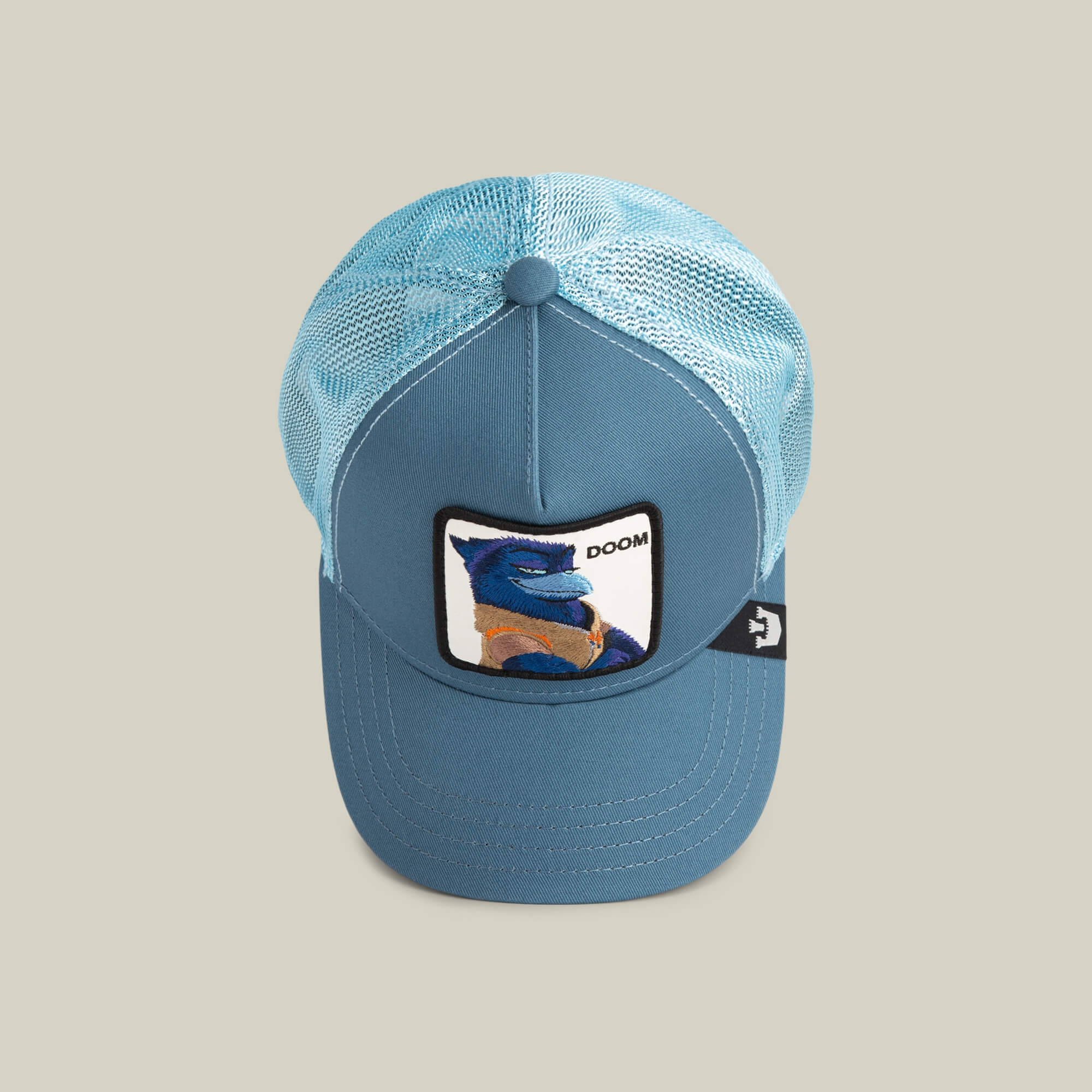 The BG2 - Doom (KIDS) by Goorin Bros. is a light blue mesh trucker hat with a front patch showing a blue dragon and “DOOM,” plus a small black tag on the left—ideal for adventurous kids.