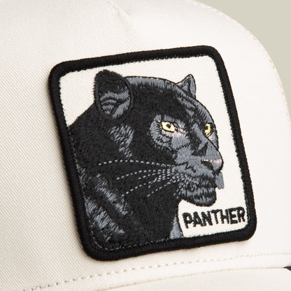 The Goorin Bros. Panther Trucker Mini is a white baseball cap with a black embroidered panther head patch featuring yellow eyes, displayed in close-up against a neutral background.
