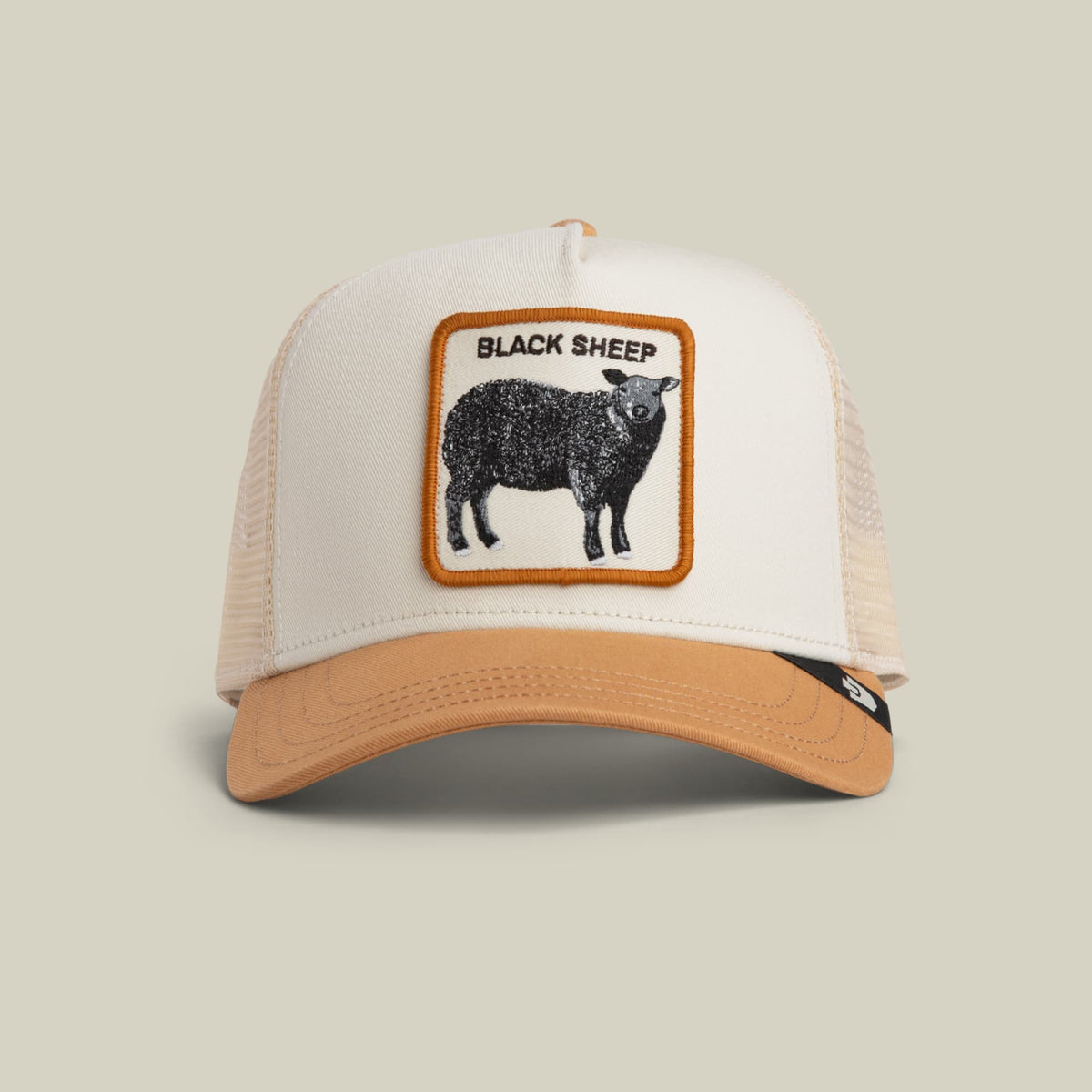 The Goorin Bros. Black Sheep Trucker Mini features a white mesh back panel and tan bill with a tan and orange bordered patch depicting a black sheep on the front. Shown on a neutral background.