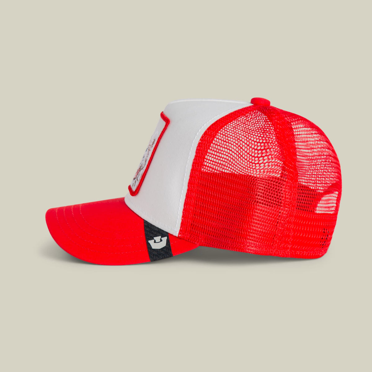 The Goorin Bros. Wild Tiger Mini trucker hat features a red and white color-blocked design with a mesh back panel and snapback closure, shown against a neutral background.