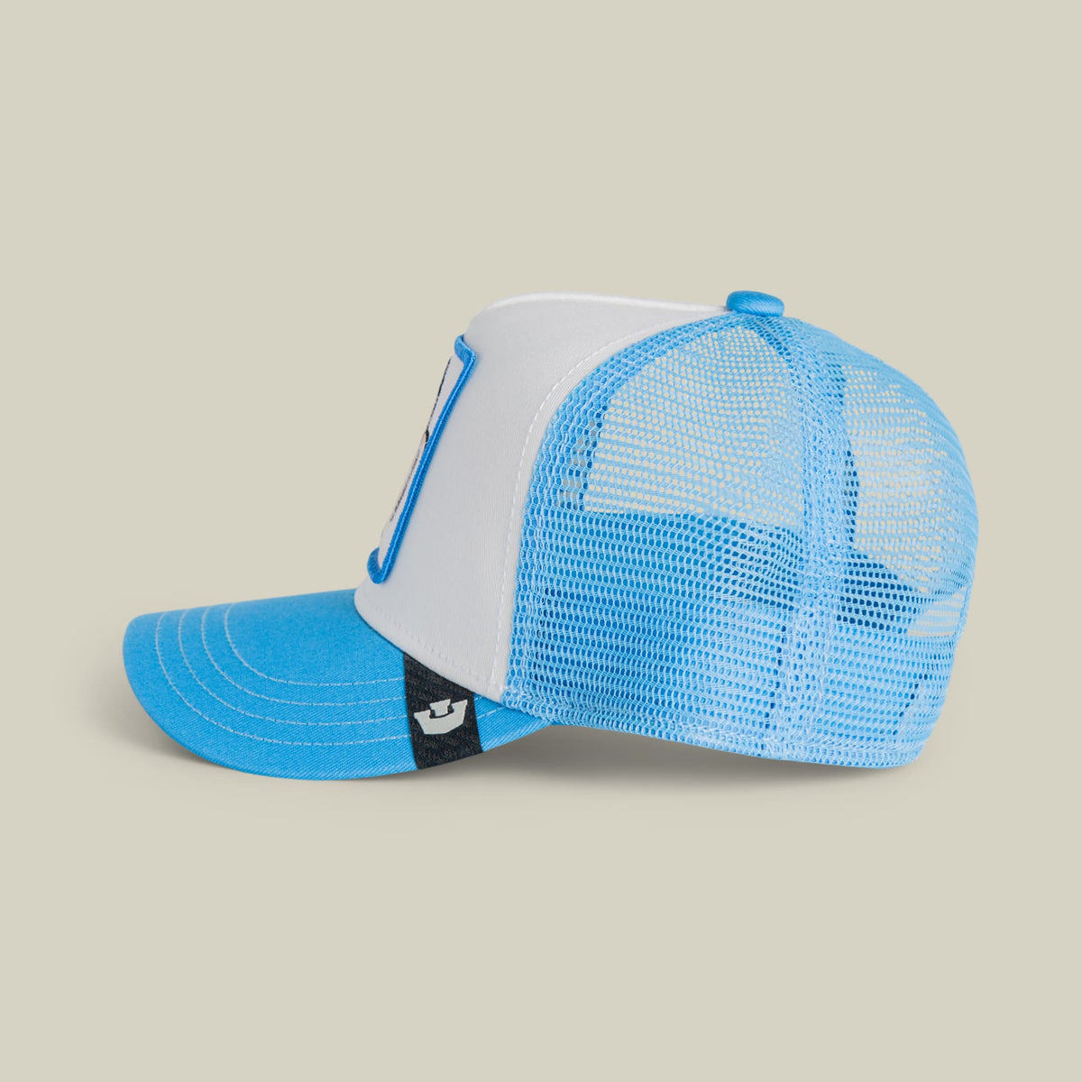 The Goorin Bros. Cool Penguin Mini trucker hat features a blue and white colorblock design with a mesh back panel, snapback closure, and small brand patch on the front. Displayed on a neutral background as a studio product shot.