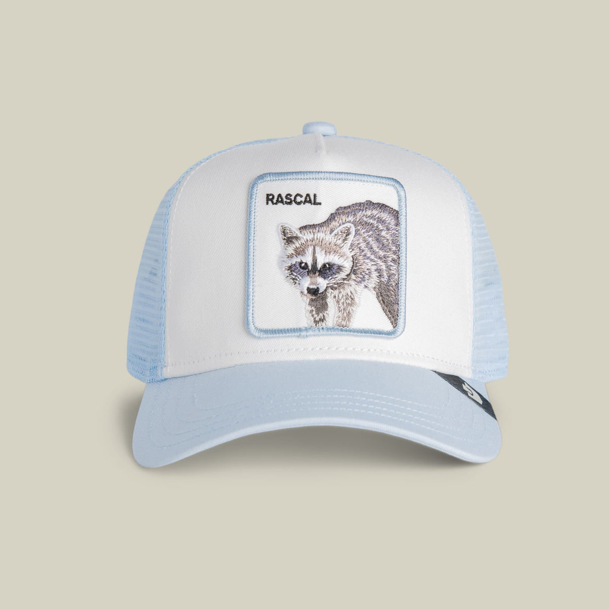 The Goorin Bros. Rascal Raccoon Mini is a light blue and white trucker hat with a mesh back and embroidered raccoon patch on the front panel, displayed on a neutral studio background.
