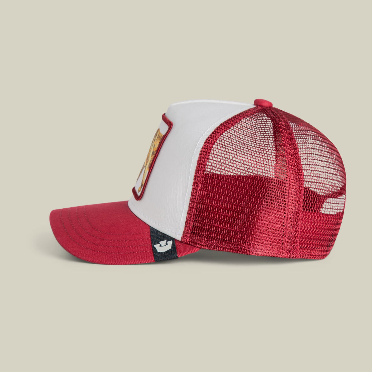 The Goorin Bros. Fierce Saber-tooth Tiger Mini trucker hat features a red and white color-blocked design with red mesh panels and an adjustable strap, displayed on a neutral studio background.