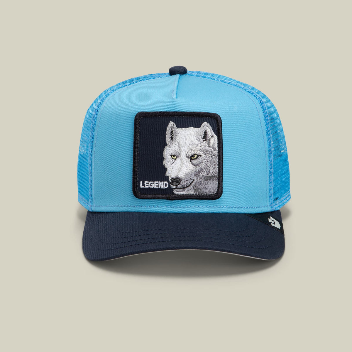 The Legend Wolf Trucker Mini by Goorin Bros is a light blue and navy mesh trucker hat with a black embroidered wolf patch featuring the word "Legend" on the front, displayed against a neutral background.