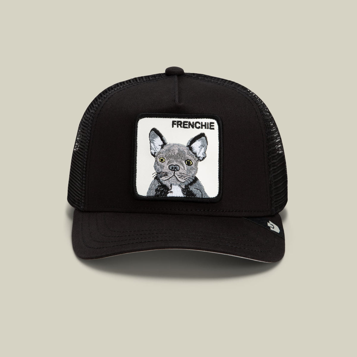 The Goorin Bros. Frenchie Trucker Mini is a black mesh-back trucker hat featuring a white embroidered patch with a detailed French Bulldog illustration and "FRENCHIE" text on the front.