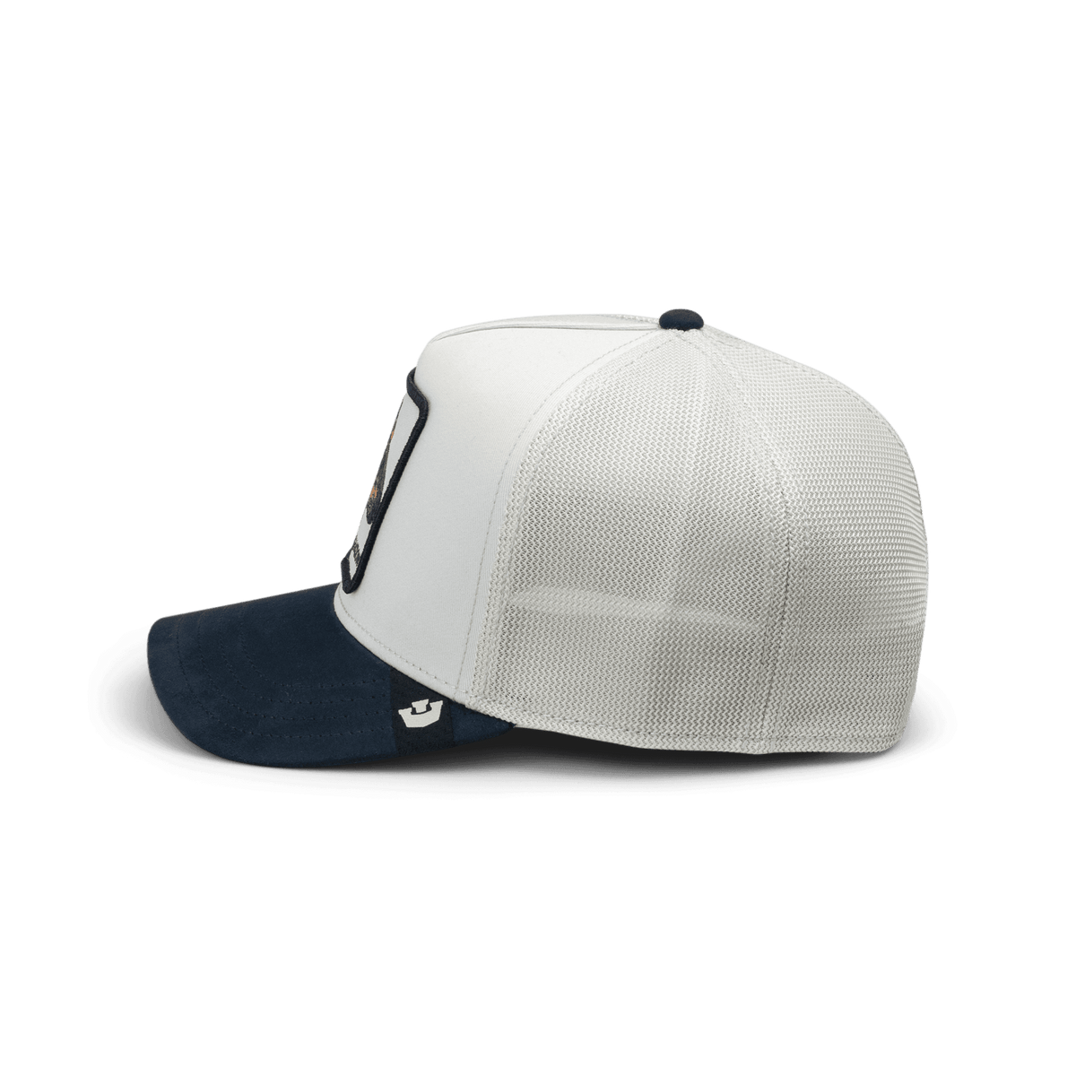 The Goorin Bros. Suede Shadow Mini trucker hat features a white suede front panel with navy blue bill and white mesh back, displayed against a black background in a side view.