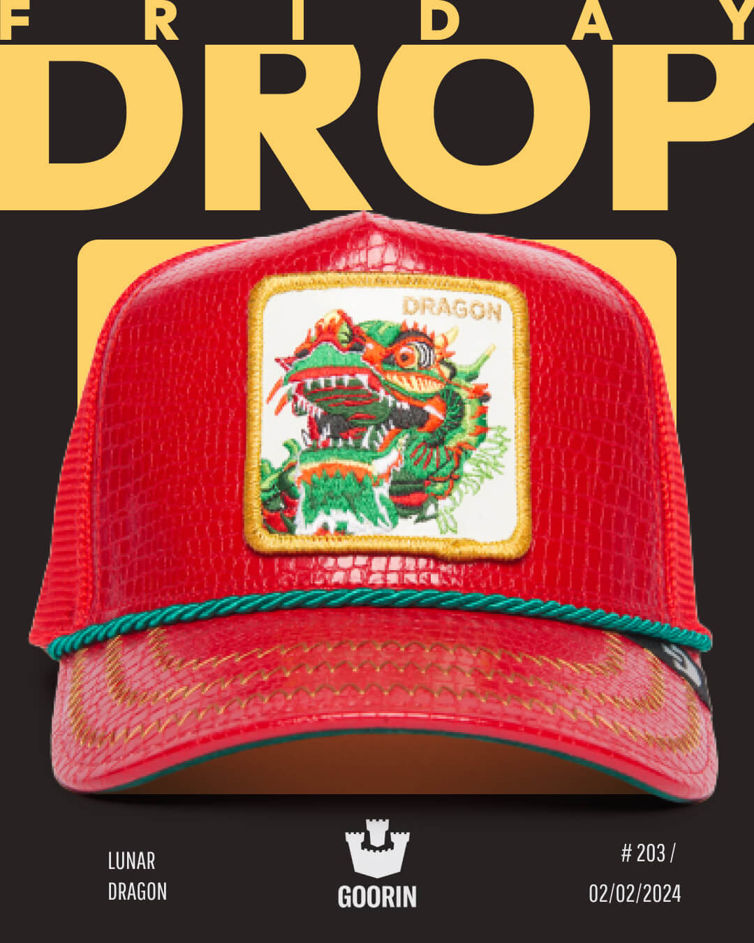 A red Goorin trucker hat with a dragon patch on the front is displayed against a black and yellow Friday Drop background, highlighting bold hat designs. Text reads: Lunar Dragon, #203, and 02/02/2024.