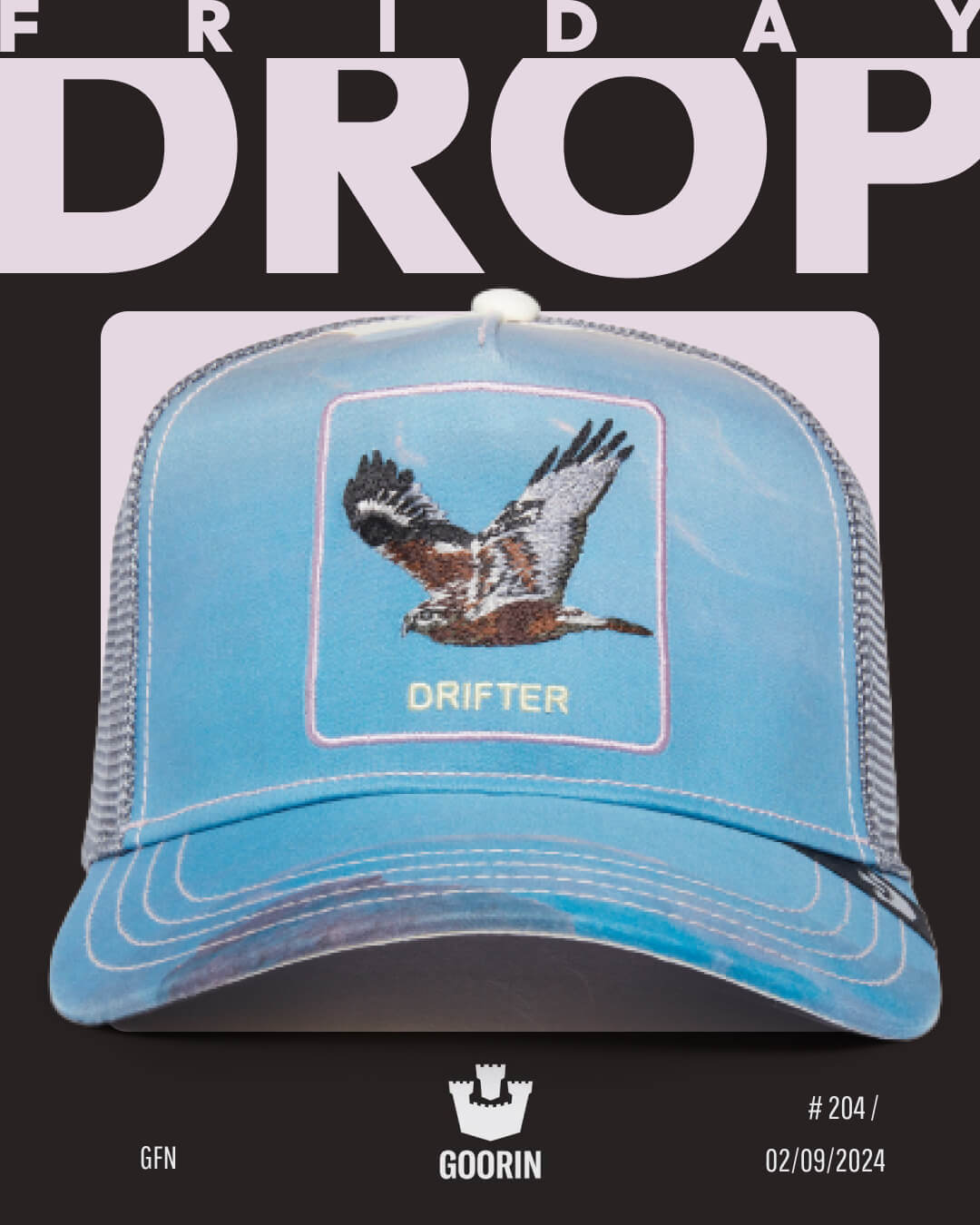A blue Goorin mesh trucker hat with an embroidered bird and the word DRIFTER on the front, displayed against a black and white FRIDAY DROP promotional background—highlighting Goorin’s reputation for durable hats.