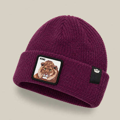 The King Beanie Mini by Goorin Bros is a burgundy knit beanie with a embroidered lion patch labeled "KING" on the front and a small woven brand label on the side, displayed on a neutral background.