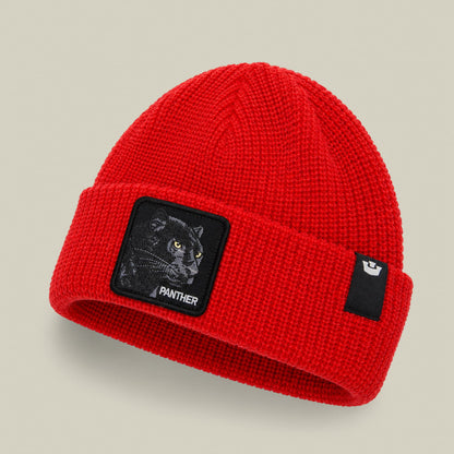 The Panther Beanie Mini by Goorin Bros is a bright red ribbed knit beanie featuring a black panther patch on the front and a small Goorin Bros logo on the side, photographed against a neutral background.