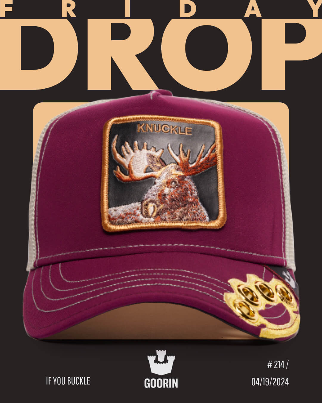 A maroon trucker hat with a mesh back, featuring a moose patch labeled KNUCKLE and a gold knuckle pin, displayed against a black background with FRIDAY DROP text. Durable hats like this stand out in any collection.
