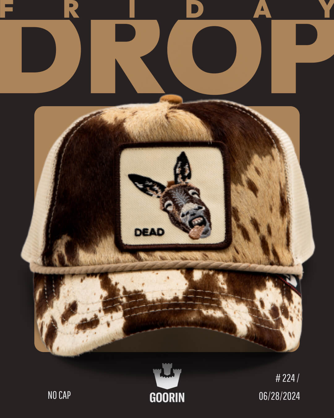 A brown and beige cow-print Goorin cap with a patch of a donkey head labeled DEAD is displayed against a black and tan background with bold text reading FRIDAY DROP.