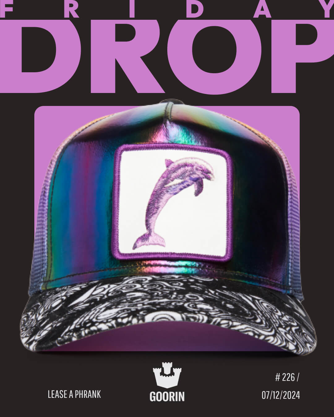 A shiny, iridescent cap with a dolphin patch on the front is featured under the text FRIDAY DROP on a promotional graphic for Goorin, highlighting their bold hat designs and signature trucker hats.