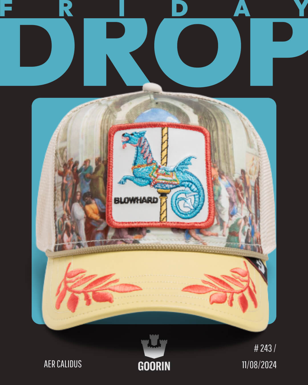 A colorful Goorin trucker hat with a dragon patch, crab designs on the brim, and a Renaissance-style background is displayed against a bold FRIDAY DROP poster.