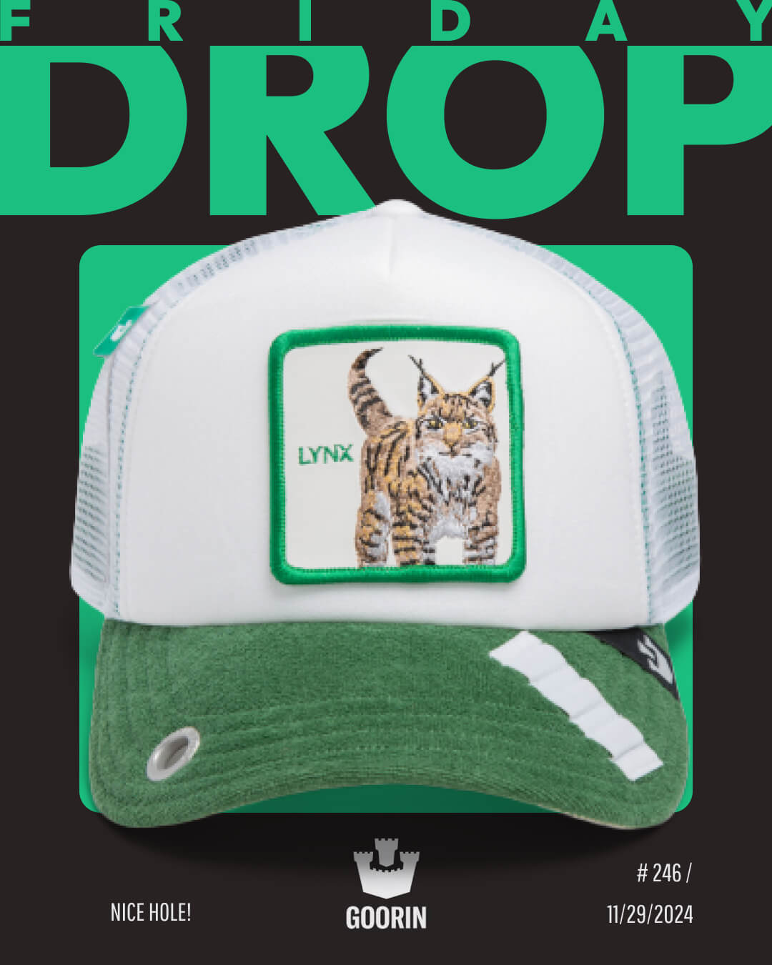A white and green Goorin trucker hat with a lynx patch is displayed against a black background with green text reading FRIDAY DROP.
