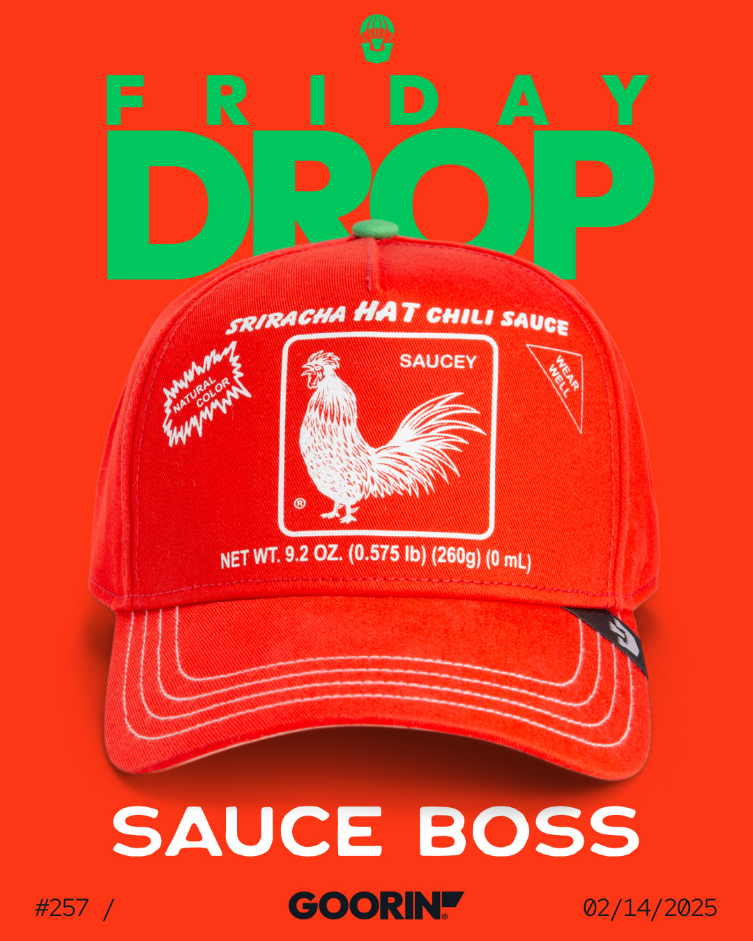 A red baseball cap with Sriracha hot chili sauce graphics is displayed on an orange background, with the text FRIDAY DROP and SAUCE BOSS above and below the hat—perfect for fans of bold style and American made trucker hats.