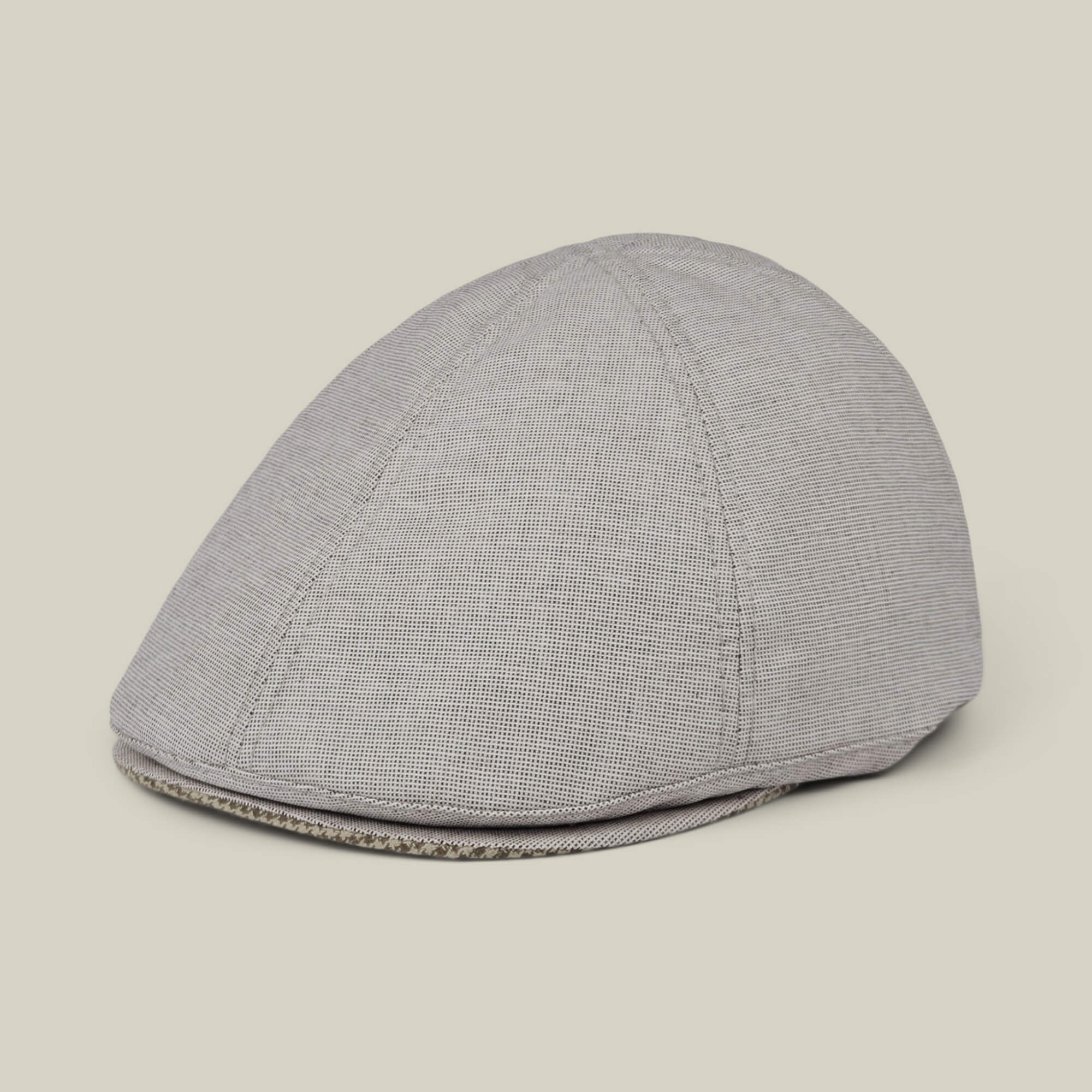 The Mile Rock by Goorin Bros. is a light gray 6-panel Ivy flat cap with subtle texture, hand cut and sewn, shown against a plain off-white background. Made in the USA.
