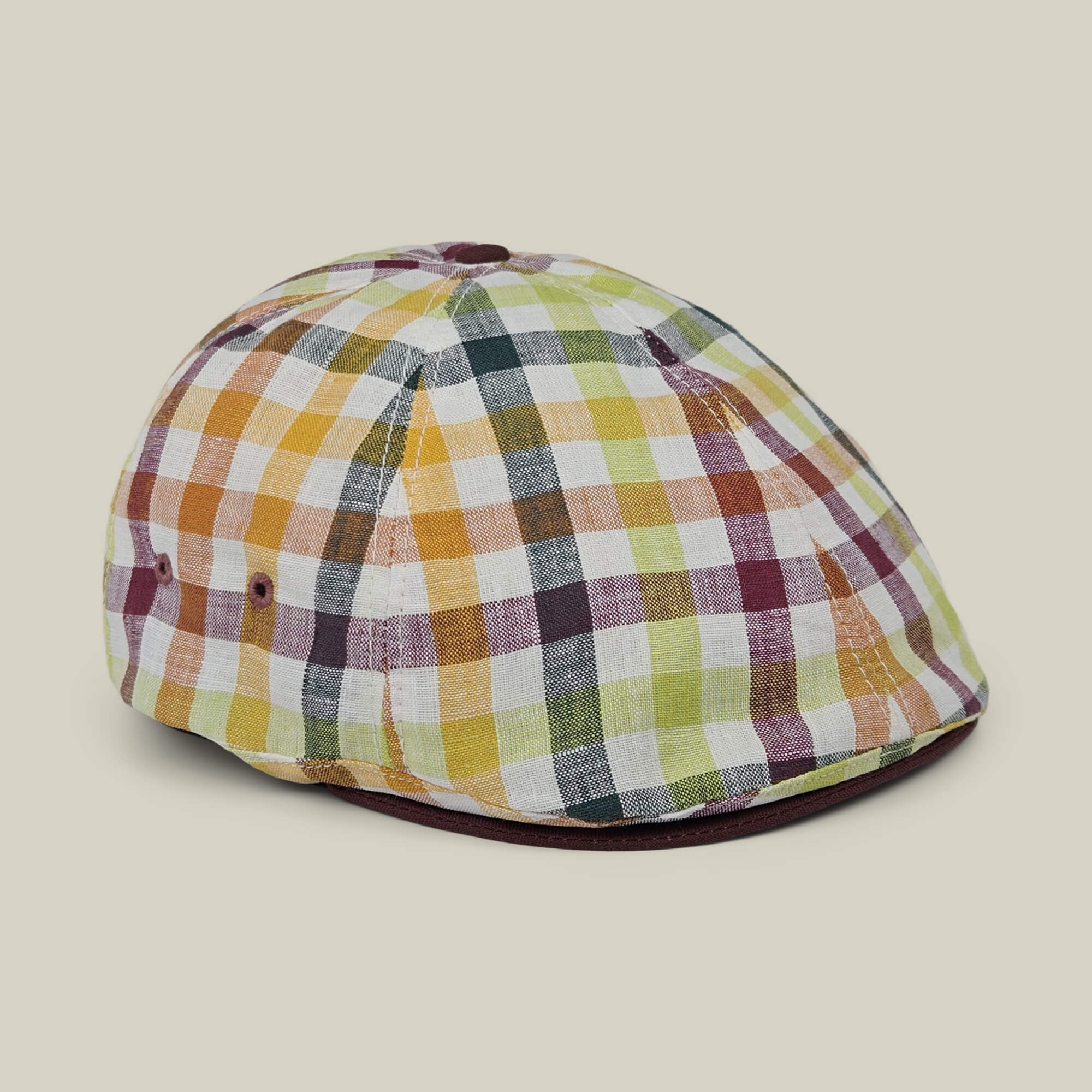 The Goorin Bros. “Point Lobos” is a 6 Panel Ivy flat cap, handmade in the USA from a breathable cotton blend, featuring a multicolored plaid design with yellow, green, burgundy, and white squares, and displayed on a neutral background.