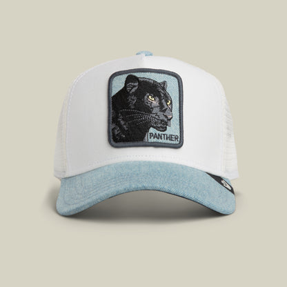 The Denim Panther by Goorin Bros. is a white and light blue trucker hat featuring a stitched patch of a black panther with the word “PANTHER” on the front, finished with a stylish denim brim.