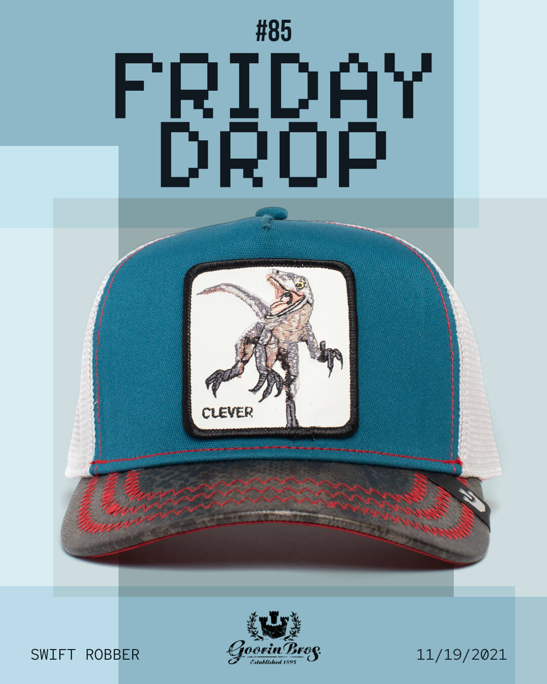 A teal and white mesh trucker hat by Goorin features a Velociraptor patch labeled CLEVER, showcased against a blue background with FRIDAY DROP #85 and SWIFT ROBBER 11/19/2021.