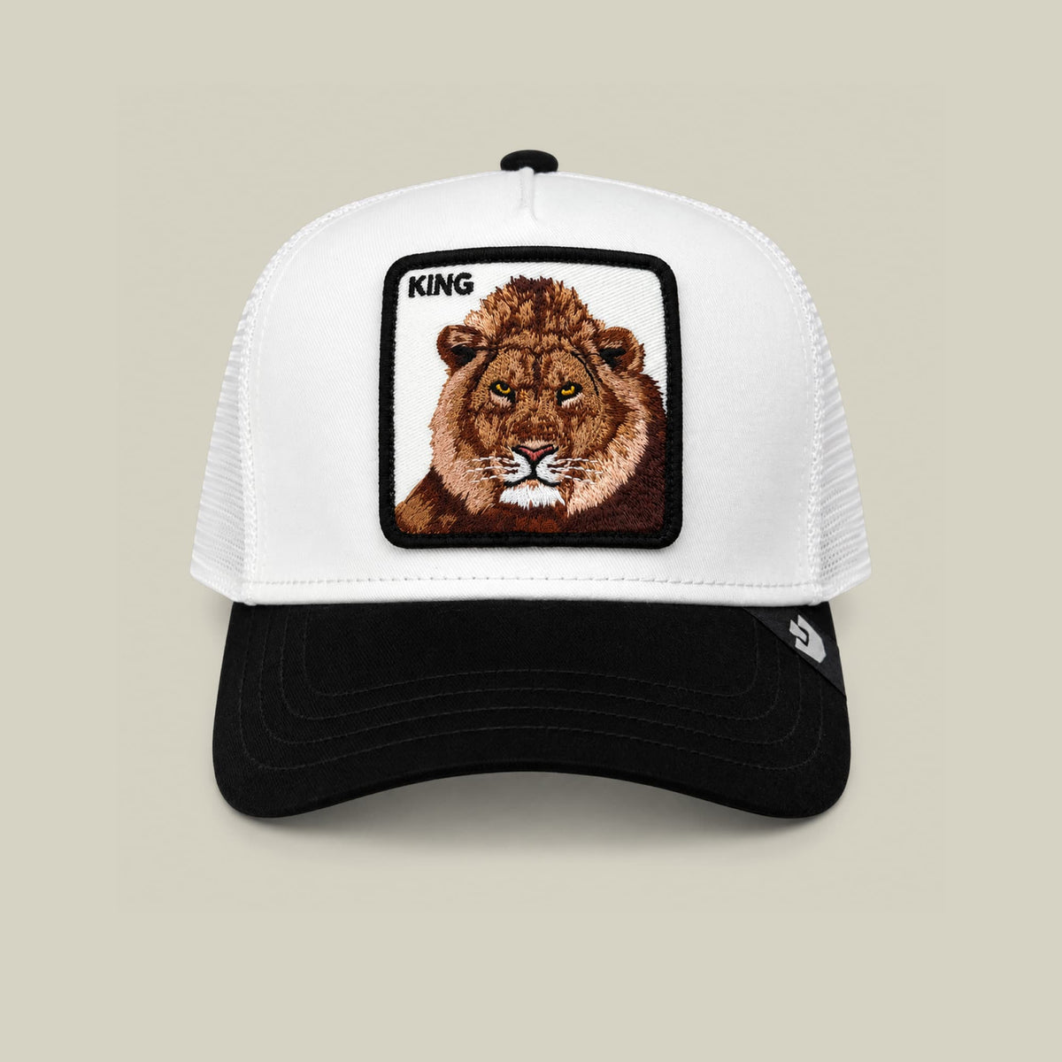 The Goorin Bros. Suede King trucker hat features a white mesh back and black suede front with an embroidered lion patch labeled "KING" on the crown, displayed against a neutral studio background.