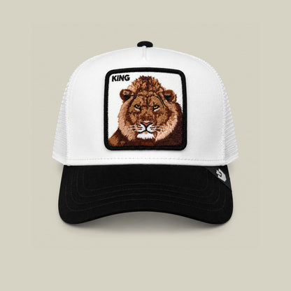 The Goorin Bros. Suede King trucker hat features a white mesh back and black suede front with an embroidered lion patch labeled "KING" on the crown, displayed against a neutral studio background.