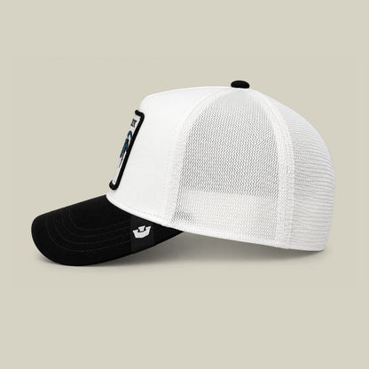 The Goorin Bros. Suede Colorful Rooster trucker hat features a white mesh back panel and black suede front with colorblock design, displayed against a neutral studio background.
