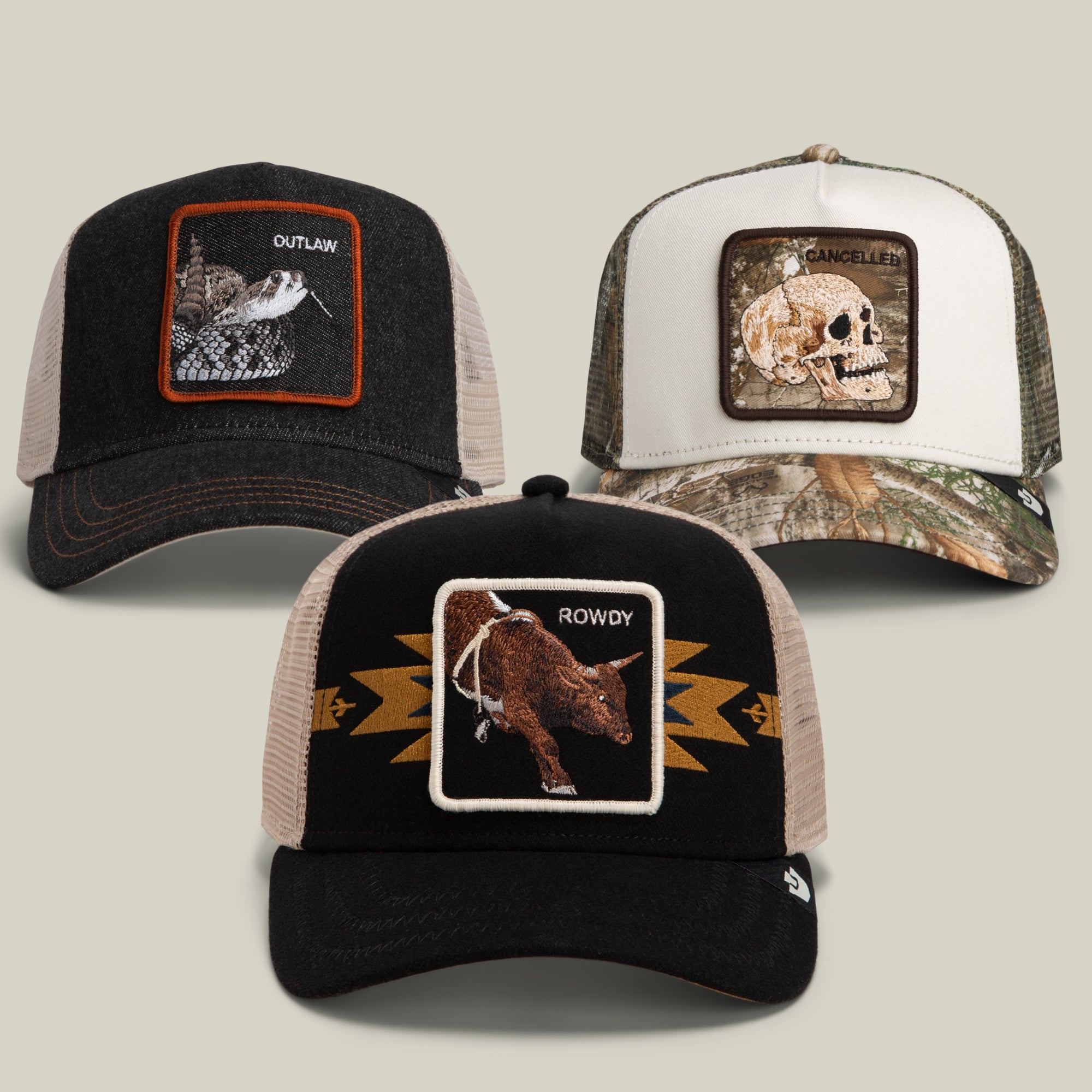 The Good Ol’ Bundle by Goorin Bros. showcases three distinct trucker hats, each adorned with a unique embroidered patch—a rattlesnake labeled OUTLAW, a skull labeled CANCELLED, and a bull labeled ROWDY. Designed for long days on the ranch or road trips down dusty trails, this bundle embodies rugged spirit and southwestern style.