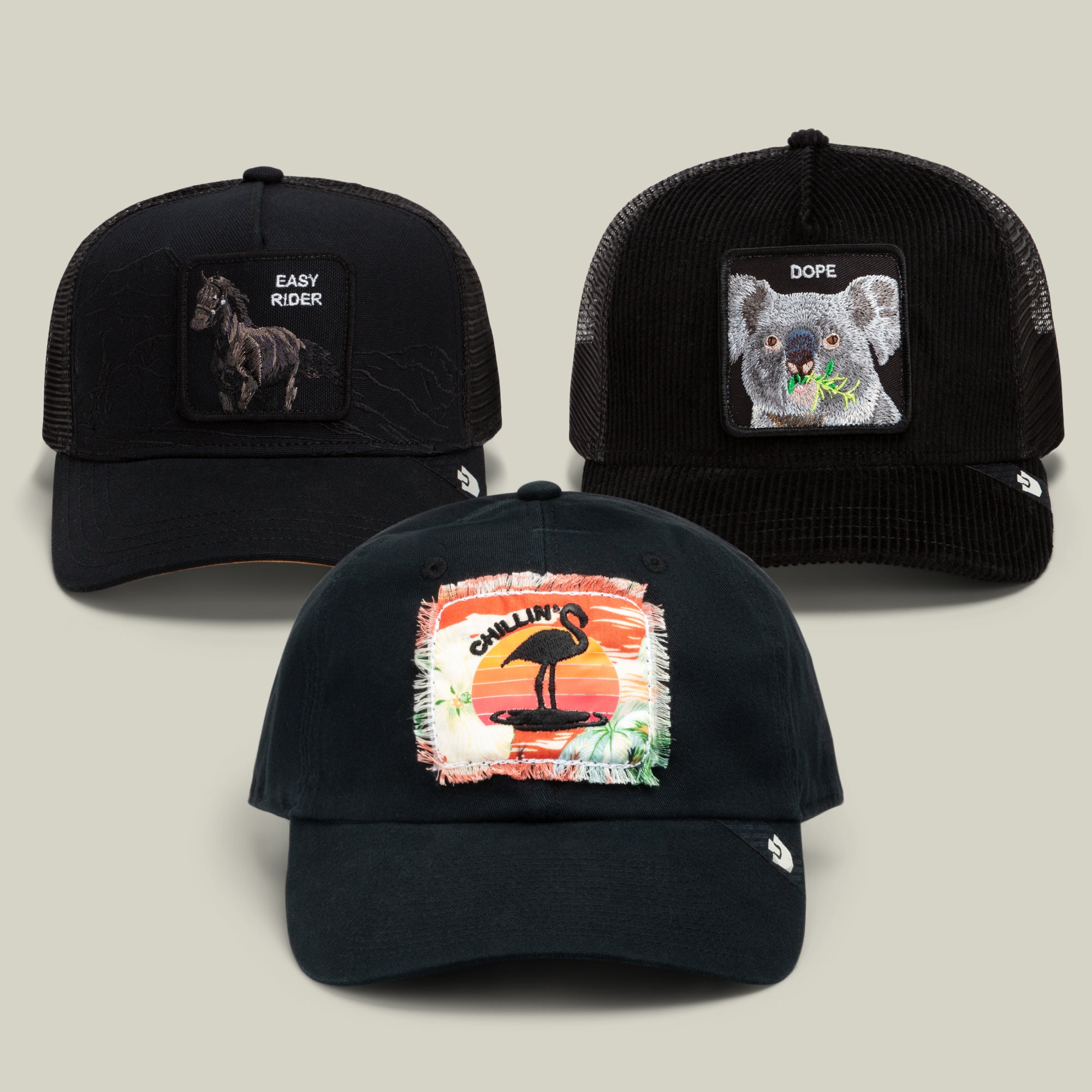The Relax, Buddy Bundle by Goorin Bros. features three all-black baseball caps with animal patches: a horse labeled Easy Rider, a koala labeled Dope, and a flamingo against an orange sunset background labeled Chillin—perfect for those who like to relax in style.