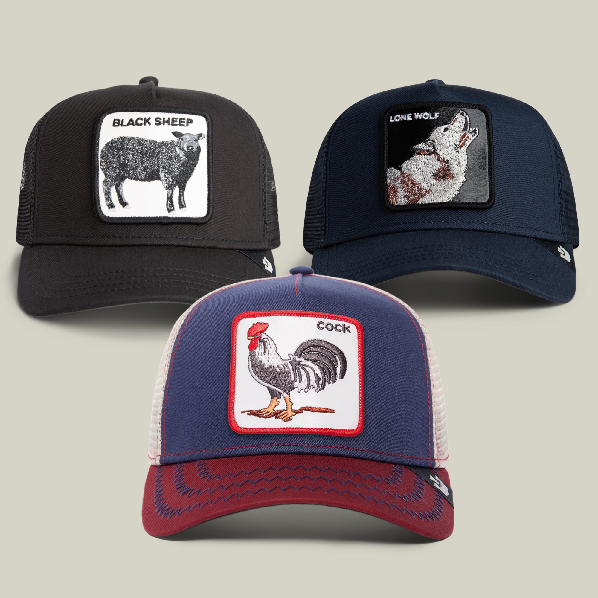 Explore the Goorin Bros. Starter Kit Bundle, showcasing three standout trucker hats: a classic black cap with a black sheep patch, a deep navy hat adorned with a striking wolf design, and a vibrant red, white, and blue hat topped with a bold rooster motif.