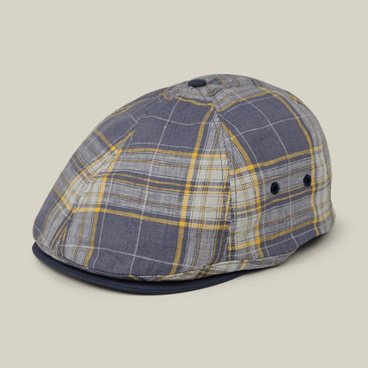 The Point Lobos 6 Panel Ivy flat cap by Goorin Bros., handmade in the USA from a breathable gray and yellow plaid cotton blend, features a button on top and two side ventilation eyelets, and is displayed on a neutral background.