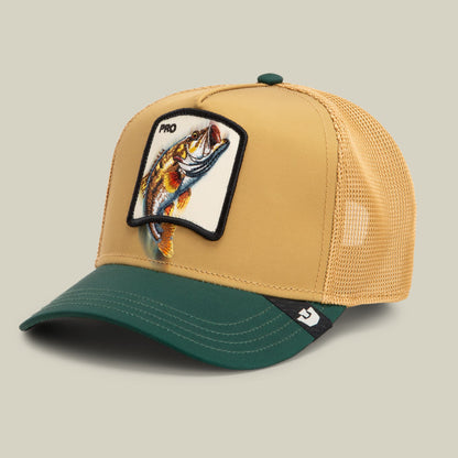 The Goorin Bros. Migration - Pro trucker hat features a tan mesh back and teal bill with an embroidered fish patch on the front, displayed against a neutral background.